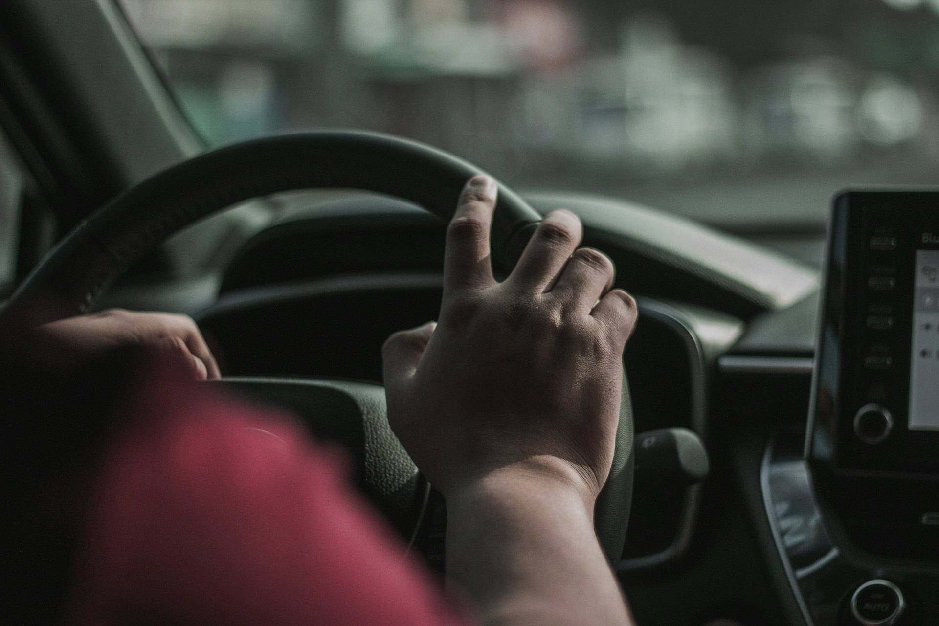 Photo: rideshare car and a phone showing a trip route